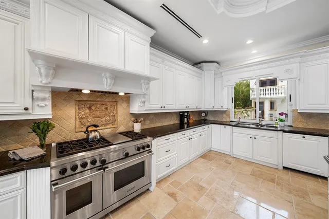 a kitchen with stainless steel appliances granite countertop a stove and a sink