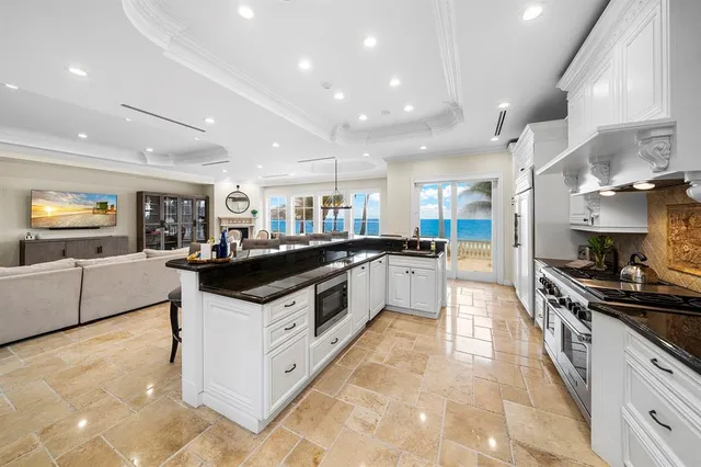a living room with furniture a fireplace and a table