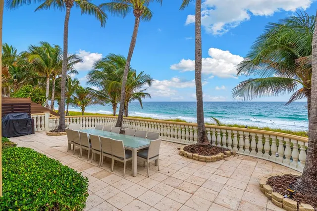 a view of a patio with a dining table and chairs