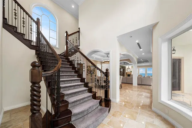 a spacious bathroom with a double vanity sink a large mirror and a bathtub