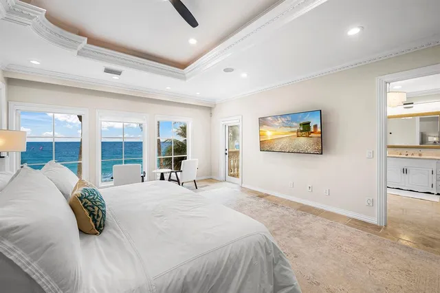 a view of a hallway with wooden floor and a bathroom