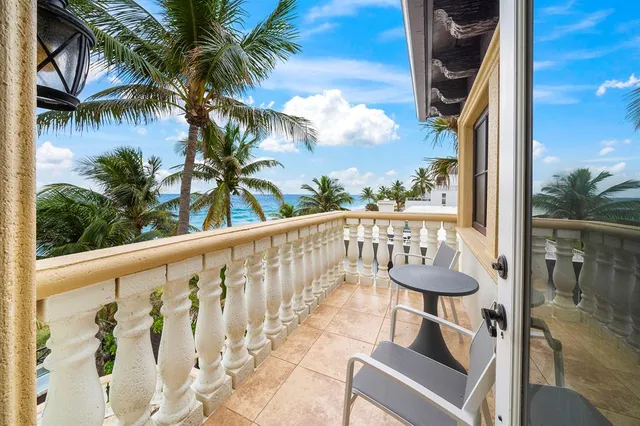 a bedroom with a large bed chandelier and a window