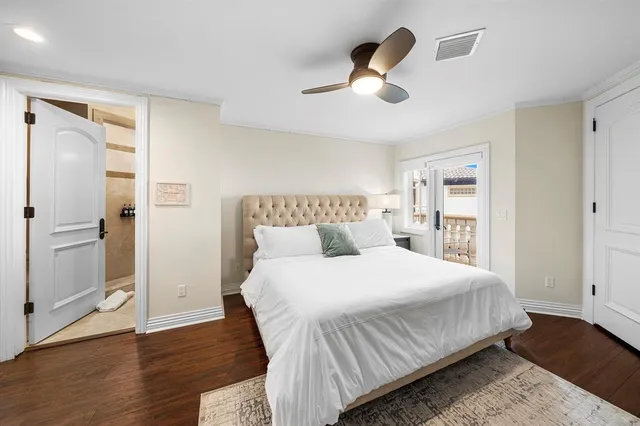 a bedroom with a bed and ceiling fan