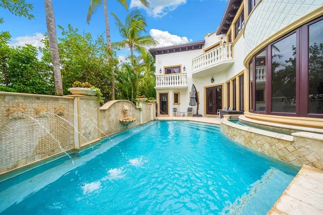 a swimming pool with some trees in the background