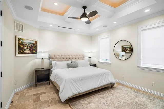 a spacious bedroom with a bed and a chandelier