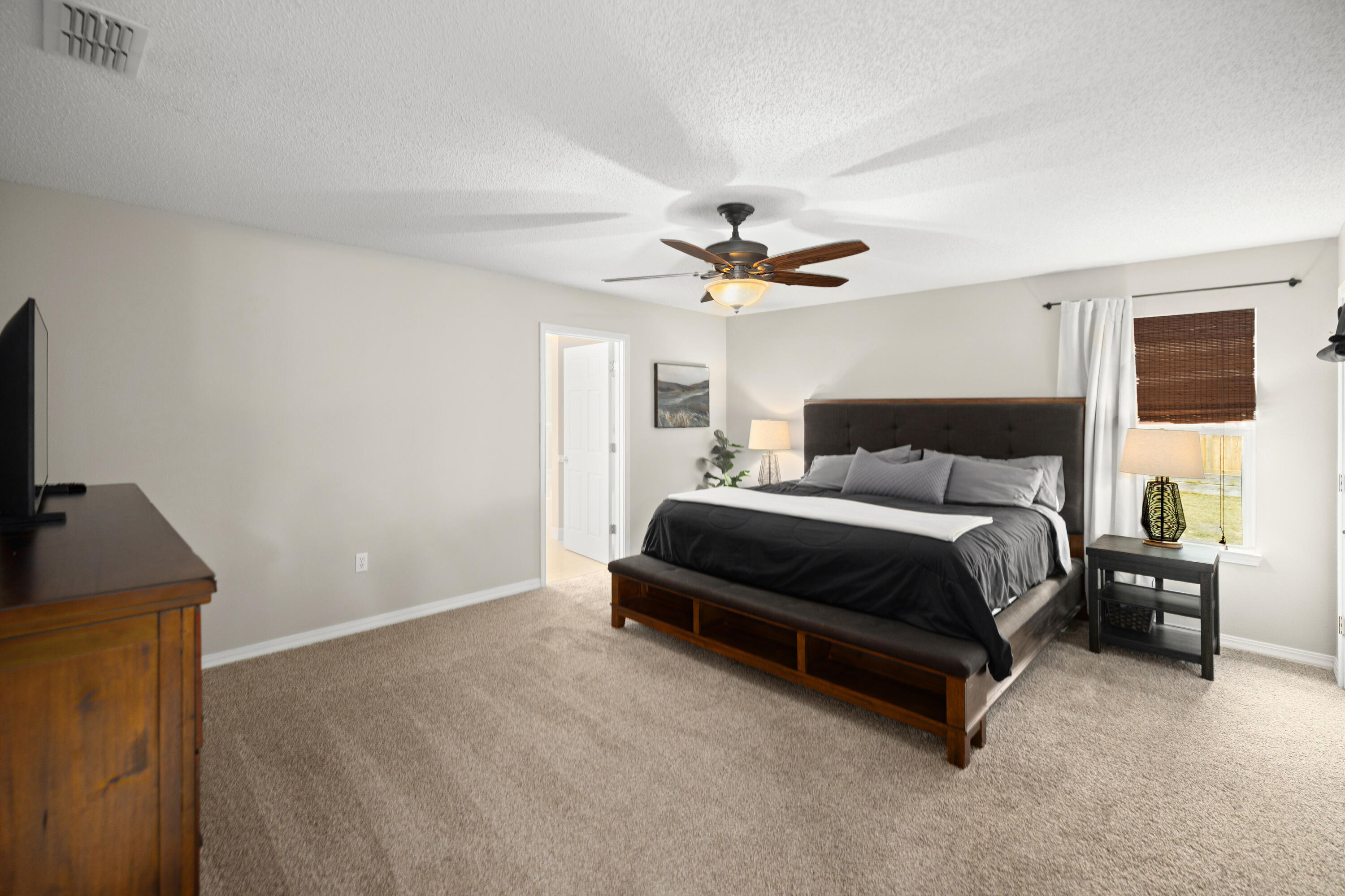 202 Limestone Circle Crestview, FL 32539 - Photo 19 of 49 a bedroom with a bed and a chandelier