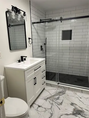 a bathroom with a sink toilet and shower