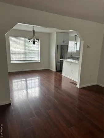 a view of a kitchen with a sink wooden floor and a kitchen