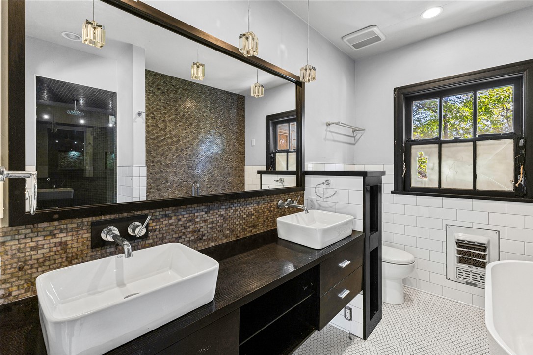 712 Banks Street Bryan, TX 77803 - Photo 15 of 33 a bathroom with a sink and a mirror