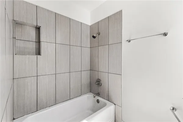 a bathroom with a bathtub and shower