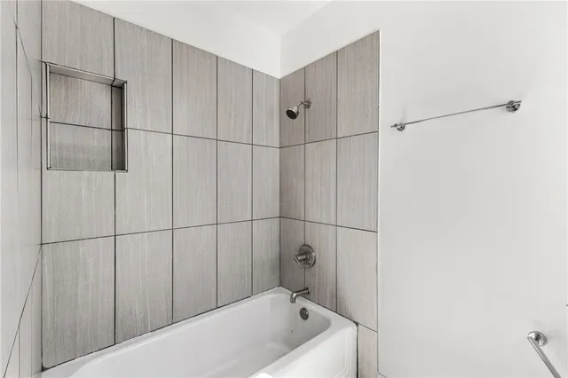 a bathroom with a bathtub and shower