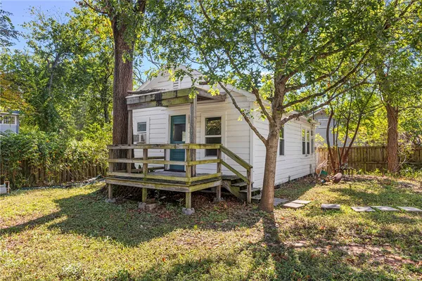 a backyard of a house with table and chairs