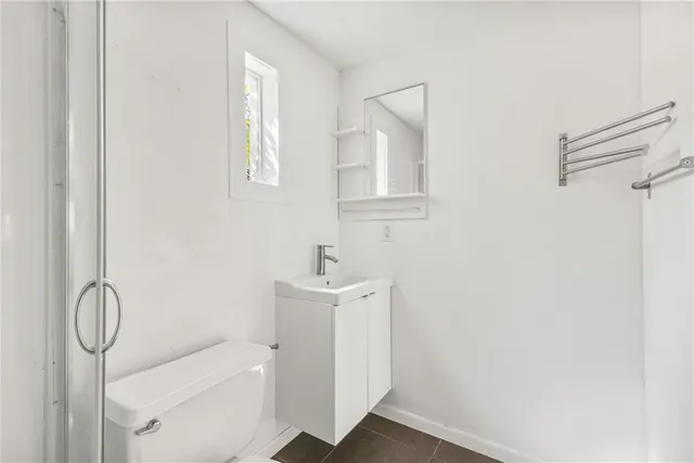 a bathroom with a toilet a sink and a mirror