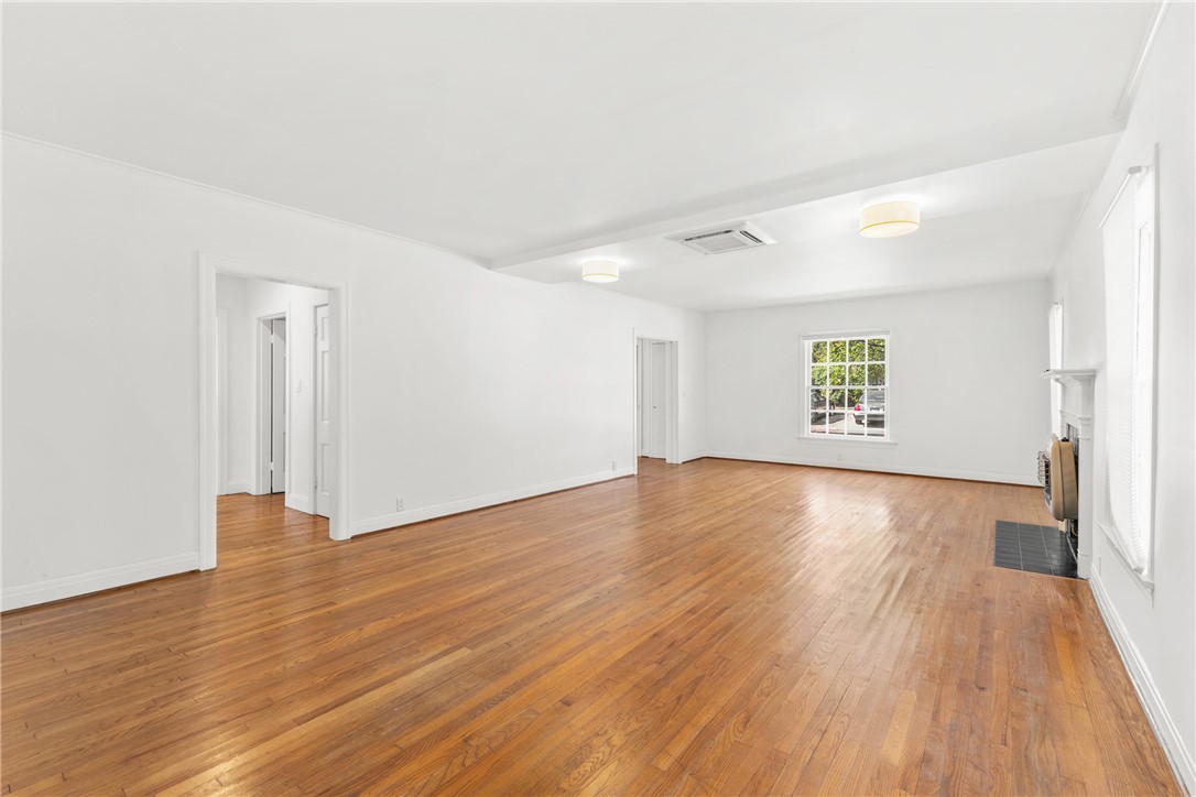 712 Banks Street Bryan, TX 77803 - Photo 4 of 33 an empty room with wooden floor and windows