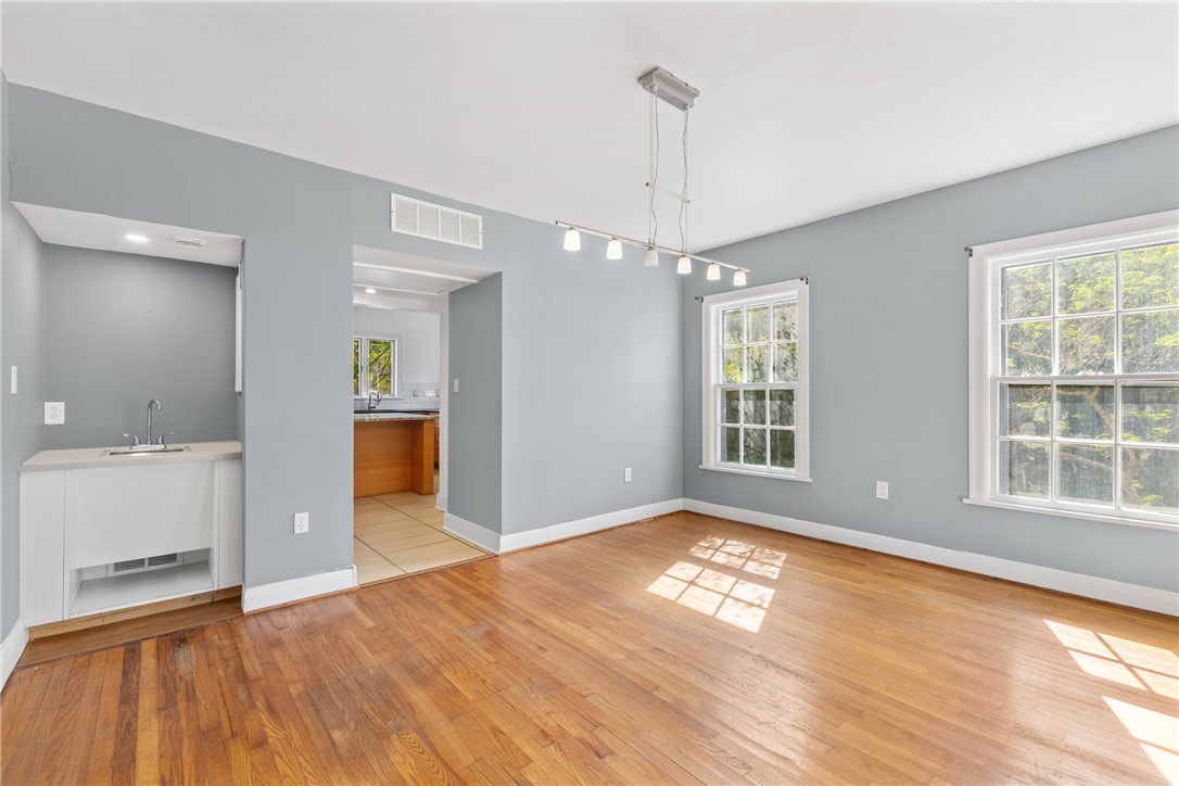 712 Banks Street Bryan, TX 77803 - Photo 5 of 33 a view of an empty room with window and wooden floor