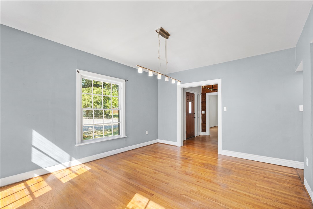 712 Banks Street Bryan, TX 77803 - Photo 6 of 33 a view of an empty room with wooden floor and a window