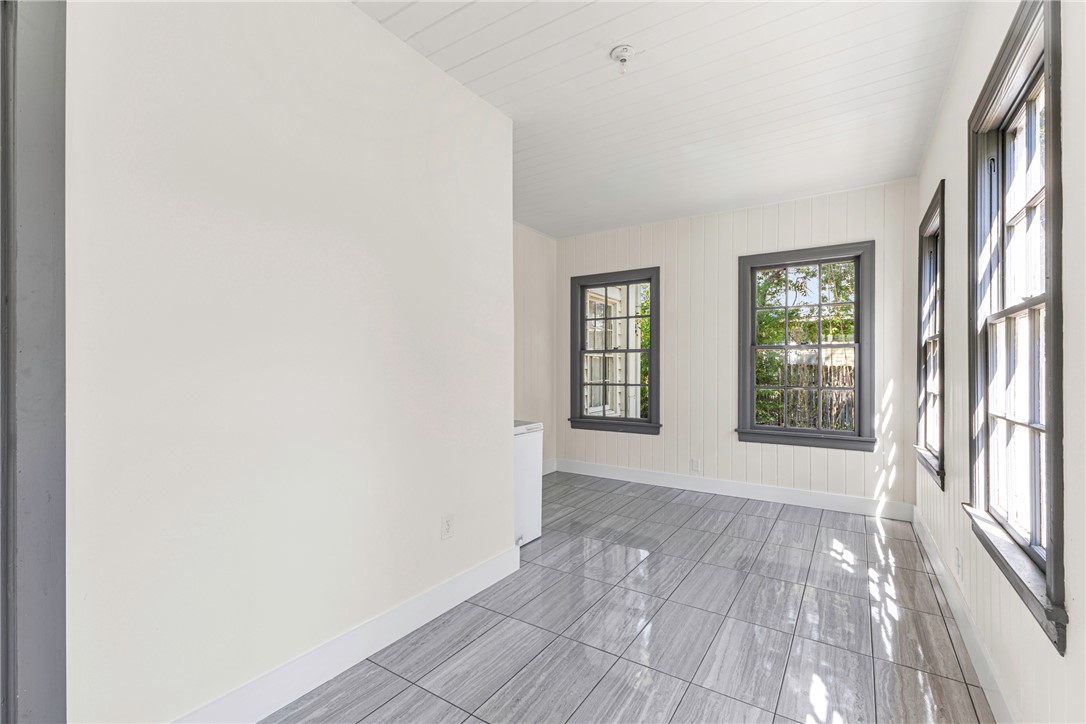 712 Banks Street Bryan, TX 77803 - Photo 10 of 33 an empty room with wooden floor and windows