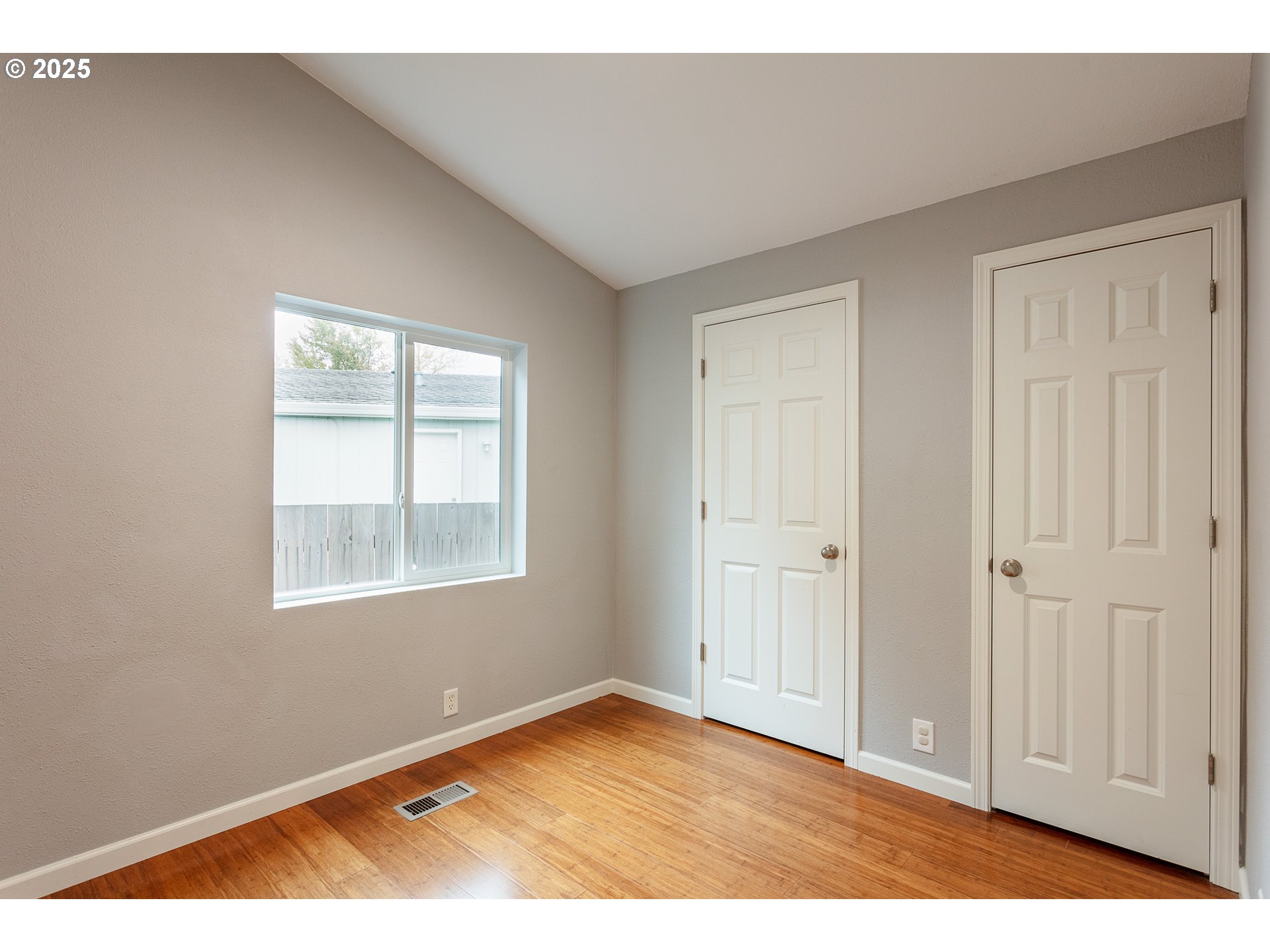 2655 Atticus Way Eugene, OR 97404 - Photo 22 of 27 a view of an empty room with wooden floor and a window