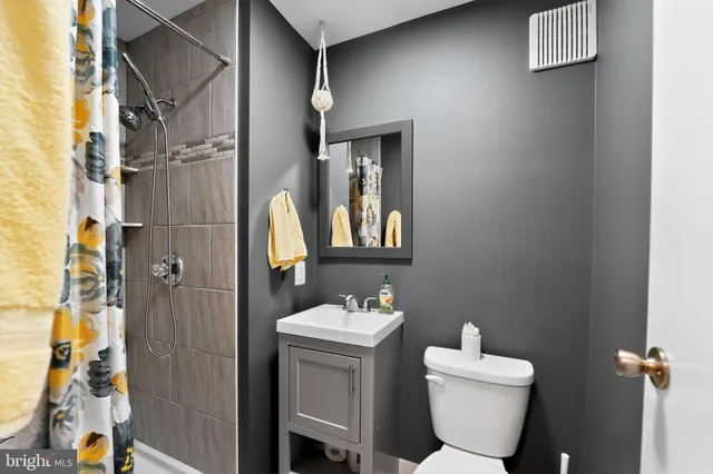 a bathroom with a toilet sink and shower