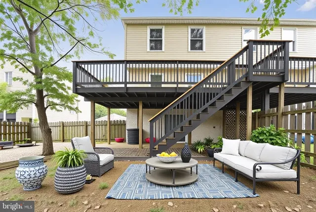 a view of a patio with couches table and chairs and potted plants