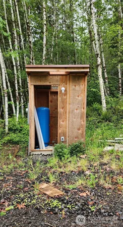 a view of a tiny house with yard