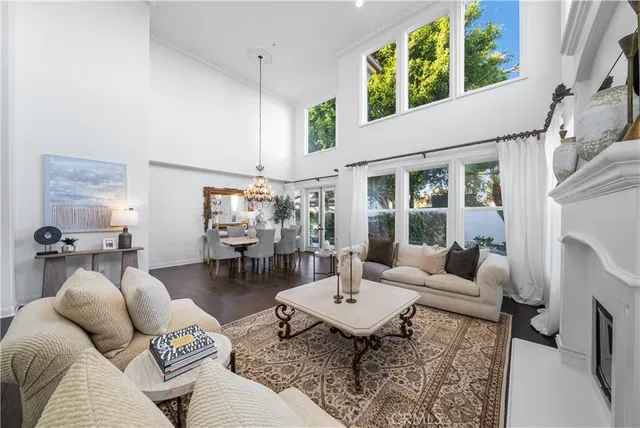 a living room with fireplace furniture and a chandelier