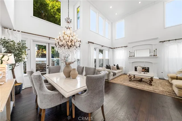 a view of a dining room with furniture and chandelier