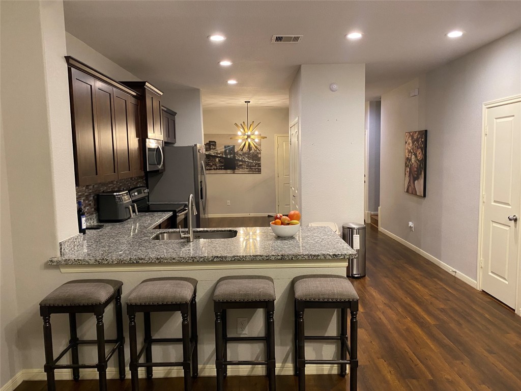 6513 Knox Street Houston, TX 77091 - Photo 3 of 10 a kitchen with stainless steel appliances granite countertop a sink and cabinets