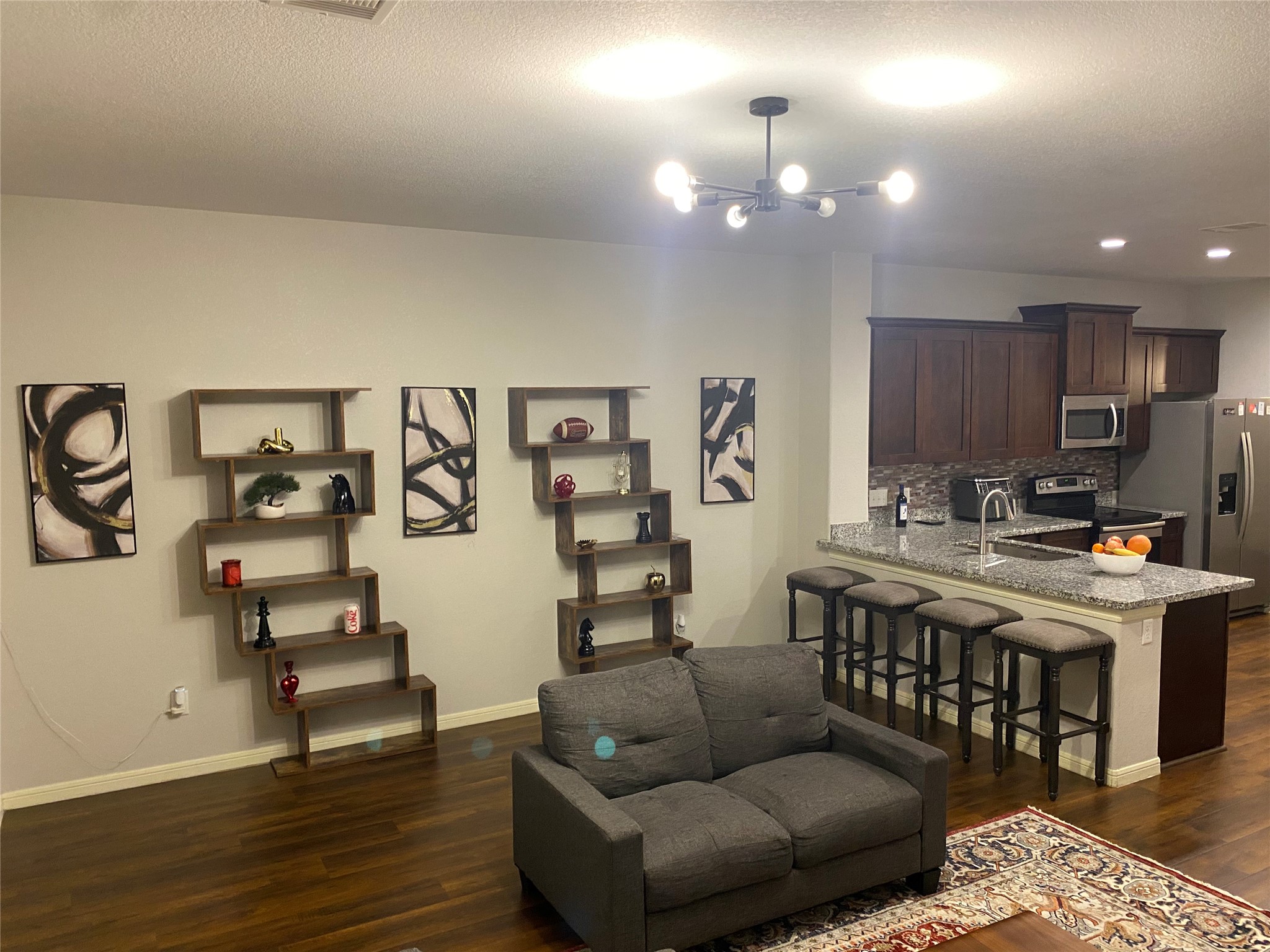 6513 Knox Street Houston, TX 77091 - Photo 4 of 10 a living room with a couch and a wooden floor