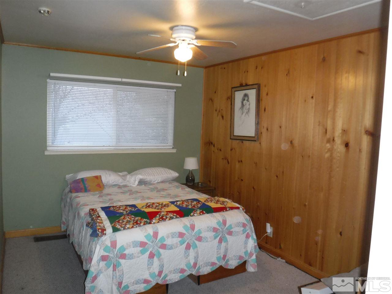 2015 Ives Avenue Reno, NV 89503 - Photo 13 of 21 a bedroom with a bed and a chandelier