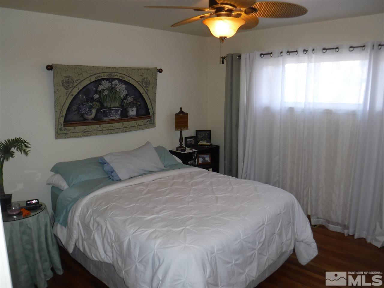 2015 Ives Avenue Reno, NV 89503 - Photo 15 of 21 a bedroom with a bed and a chandelier