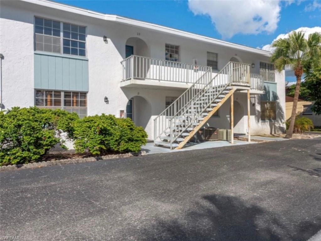 4900 Biscayne Drive, Unit 23 Naples, FL 34112 - Photo 12 of 12 front view of a house with a yard