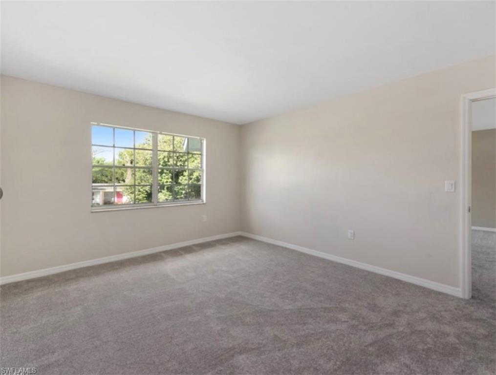 4900 Biscayne Drive, Unit 23 Naples, FL 34112 - Photo 6 of 12 an empty room with windows