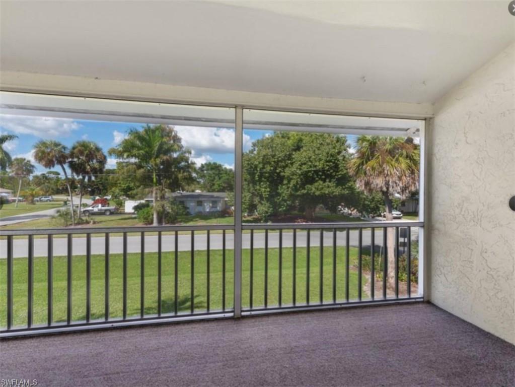 4900 Biscayne Drive, Unit 23 Naples, FL 34112 - Photo 10 of 12 a view of a porch with a yard