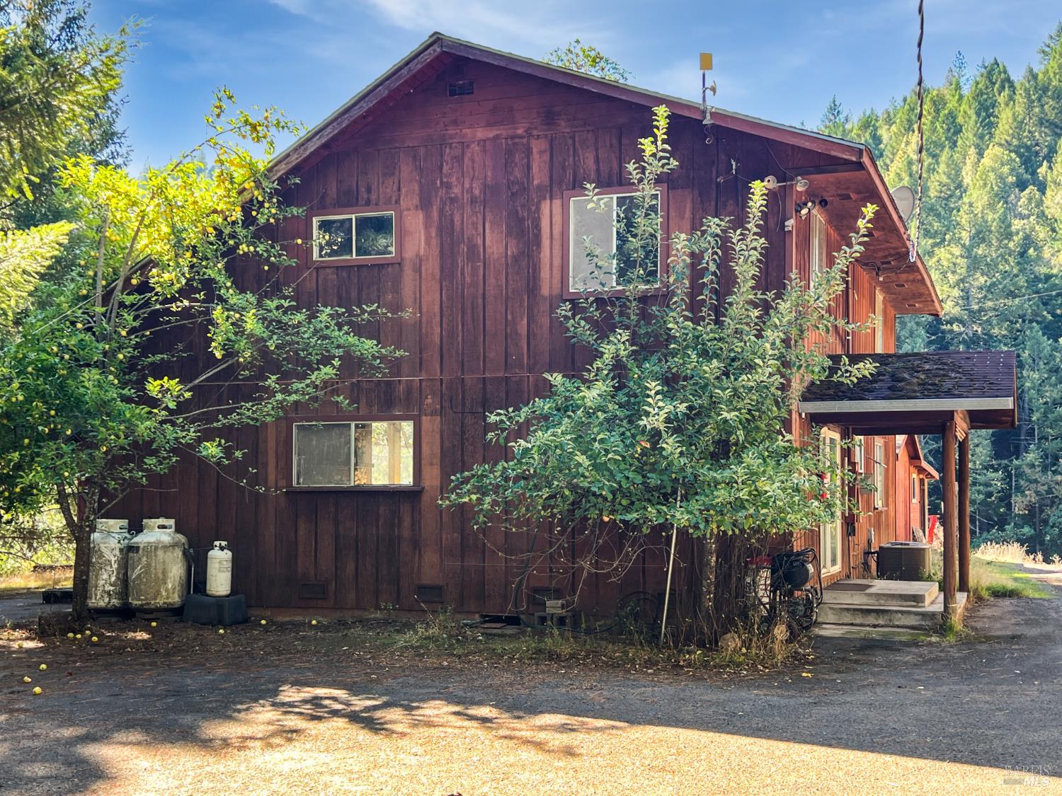 8555 Cave Creek Road Redwood Valley, CA 95470 - Photo 1 of 9 a view of a house with brick walls and potted plants