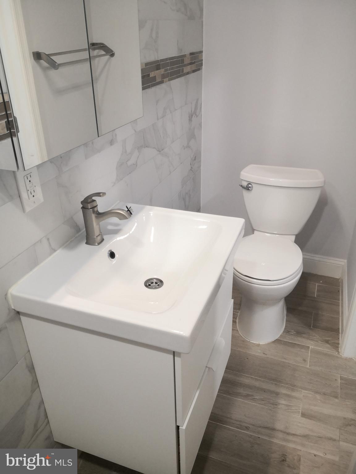 1008 Green Street Philadelphia, PA 19123 - Photo 18 of 40 a bathroom with a sink a toilet and a mirror