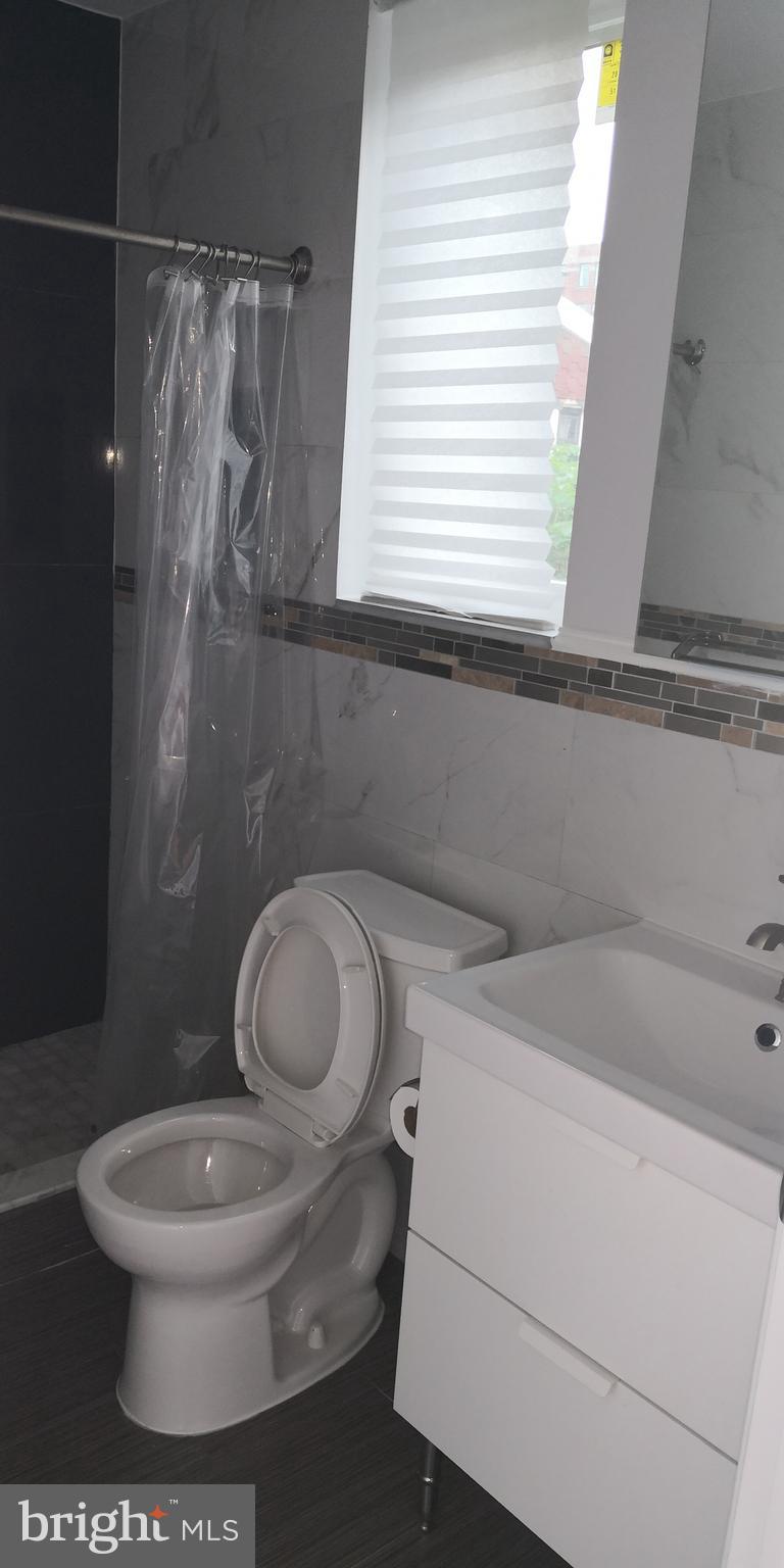 1008 Green Street Philadelphia, PA 19123 - Photo 36 of 40 a white toilet sitting next to a bathroom sink