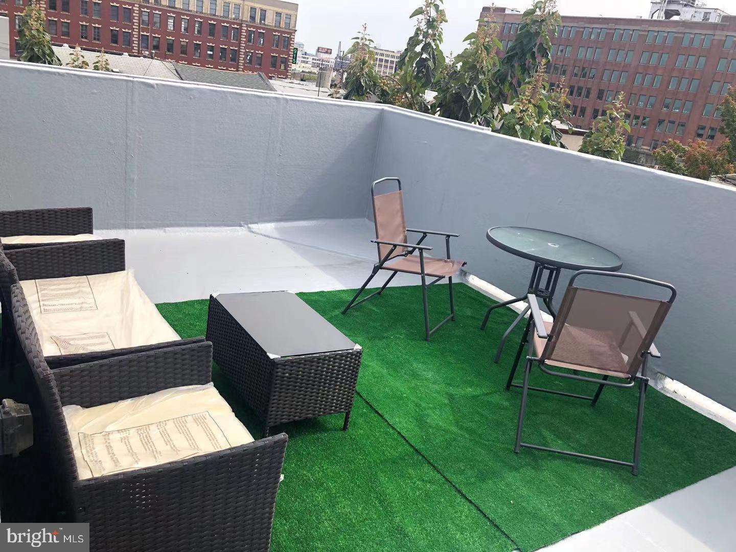 1008 Green Street Philadelphia, PA 19123 - Photo 7 of 40 a view of a chairs and table in the backyard