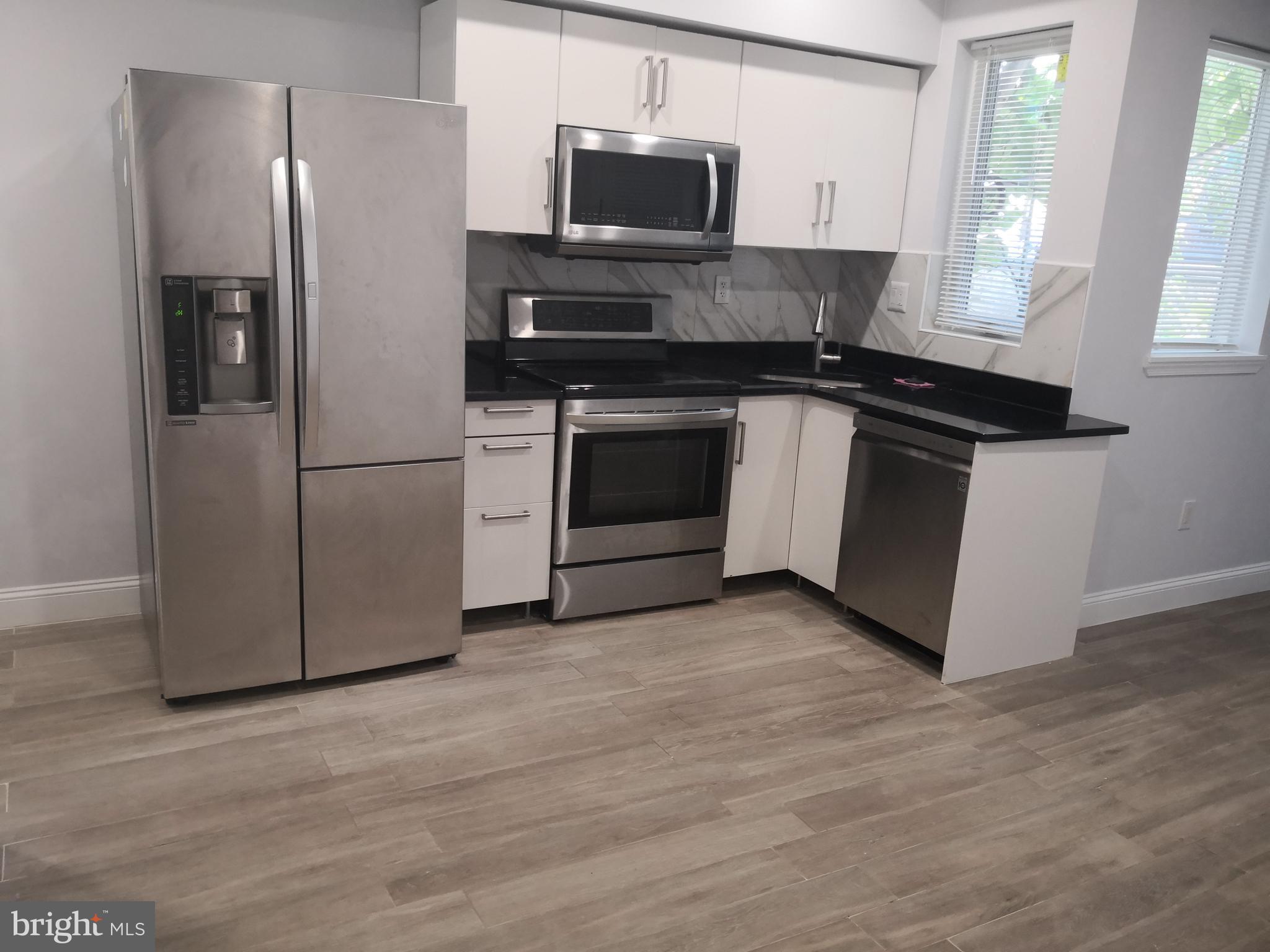 1008 Green Street Philadelphia, PA 19123 - Photo 9 of 40 a kitchen with a stove microwave and refrigerator