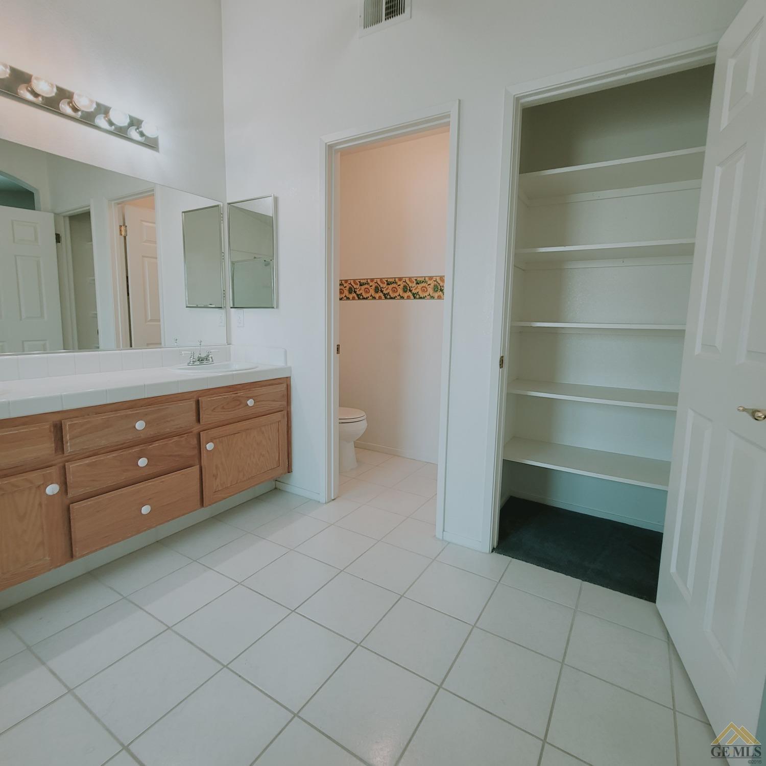 Undisclosed Address Bakersfield, CA 93313 - Photo 18 of 24 a room with a cabinets and a wooden floor