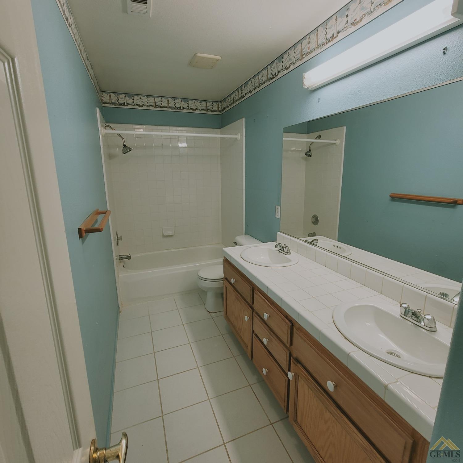 Undisclosed Address Bakersfield, CA 93313 - Photo 20 of 24 a bathroom with a granite countertop sink a toilet and shower