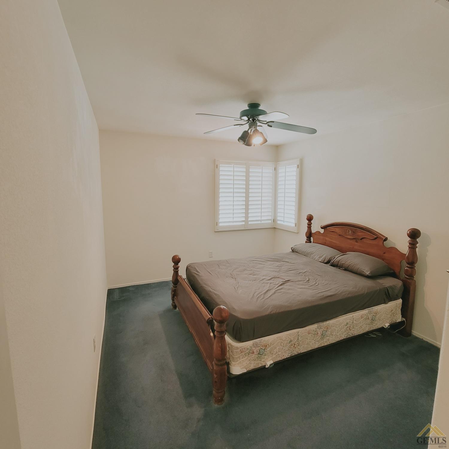Undisclosed Address Bakersfield, CA 93313 - Photo 21 of 24 a bedroom with a bed and window