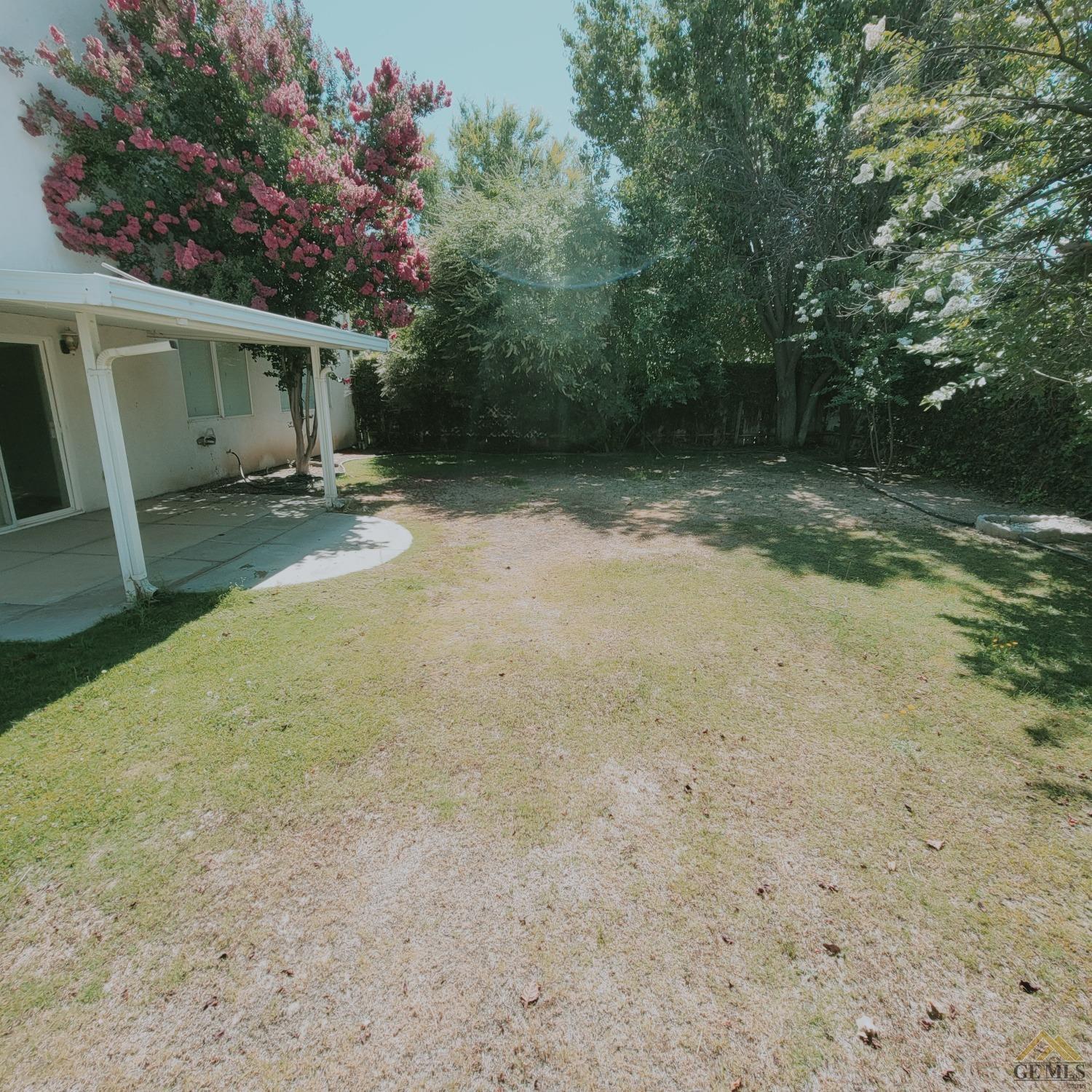 Undisclosed Address Bakersfield, CA 93313 - Photo 24 of 24 a backyard of a house with lots of green space