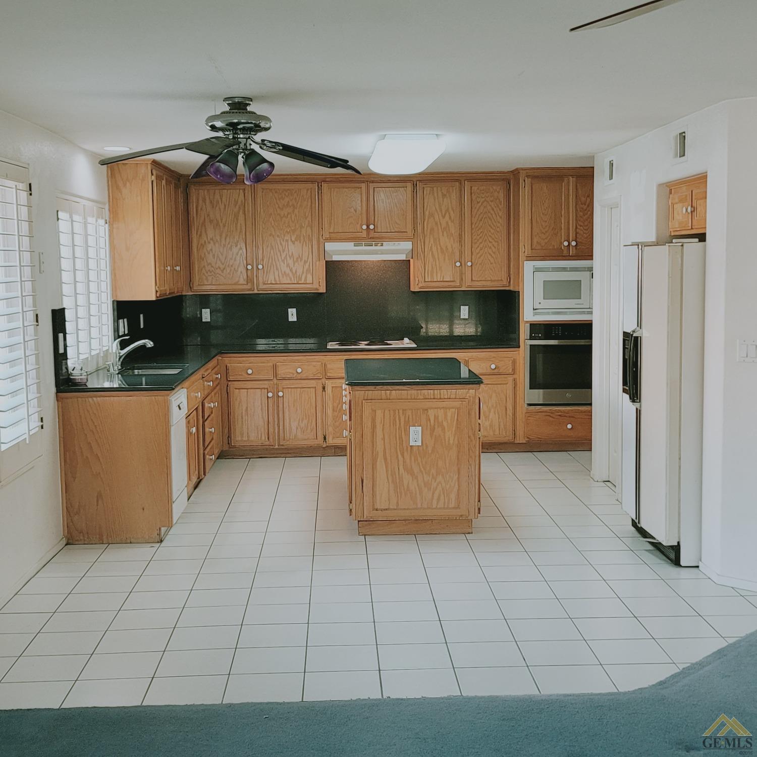 Undisclosed Address Bakersfield, CA 93313 - Photo 3 of 24 a kitchen with stainless steel appliances granite countertop a stove a sink and a refrigerator