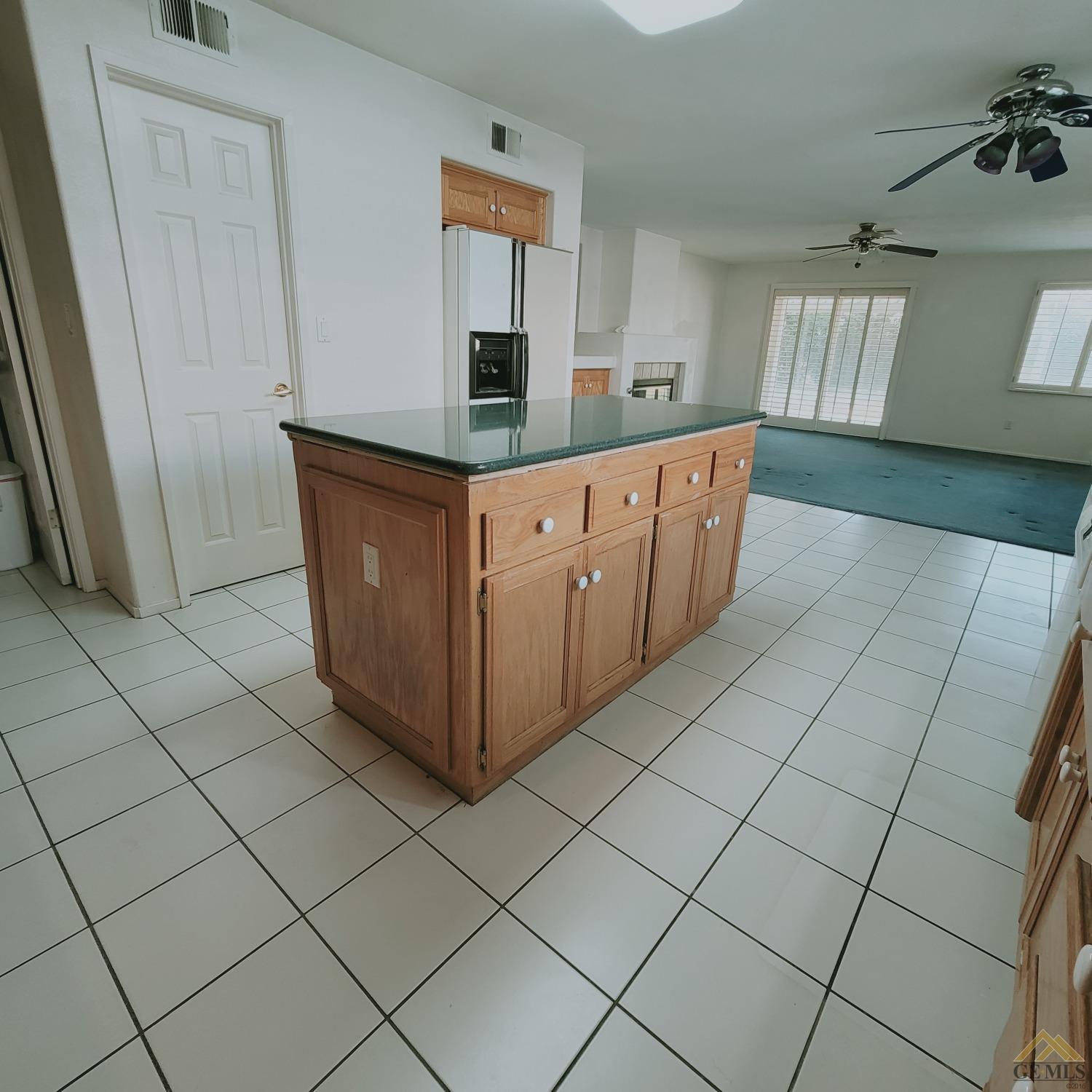 Undisclosed Address Bakersfield, CA 93313 - Photo 4 of 24 a kitchen with stainless steel appliances a sink and cabinets
