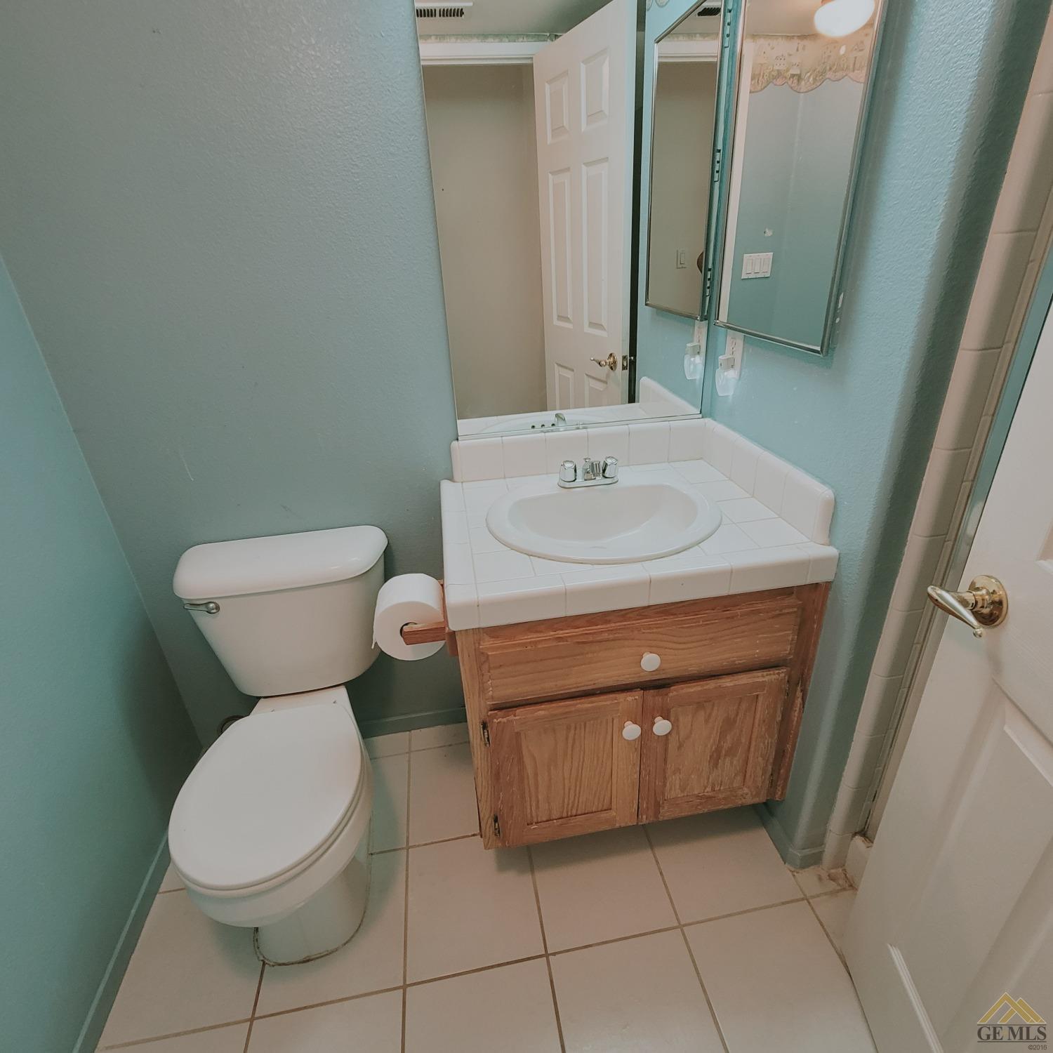Undisclosed Address Bakersfield, CA 93313 - Photo 9 of 24 a bathroom with a toilet sink and mirror