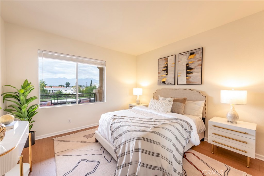 208 North Lincoln Avenue, Unit 309 Monterey Park, CA 91755 - Photo 11 of 26 a bedroom with a bed and a large window