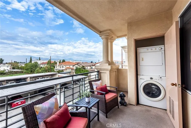a view of a chairs and table in a balcony