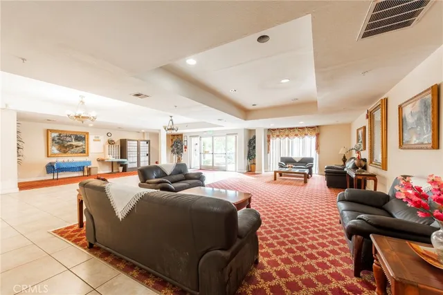 a bedroom with furniture and a large window