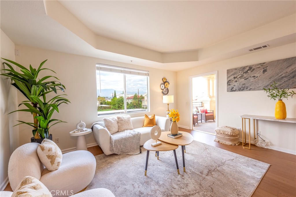 208 North Lincoln Avenue, Unit 309 Monterey Park, CA 91755 - Photo 4 of 26 a living room with furniture potted plant and a large window